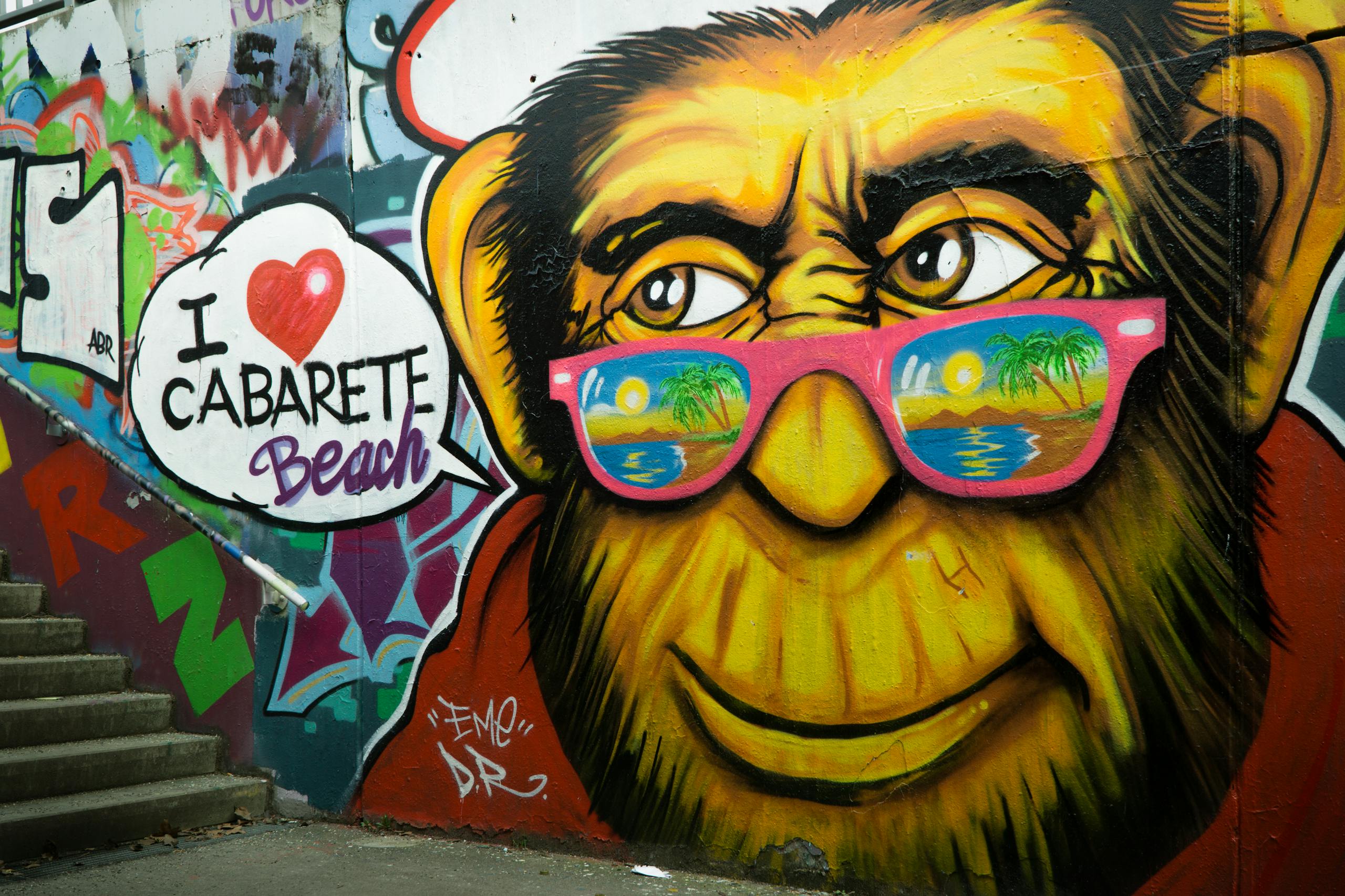 Colorful street art of a monkey with sunglasses on stairs, featuring Cabarete Beach text.